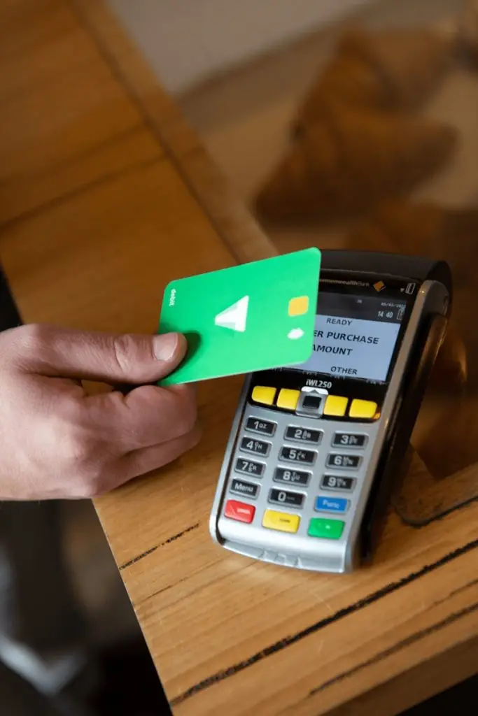 OAS Payments 2025: a person holding a credit card next to a calculator