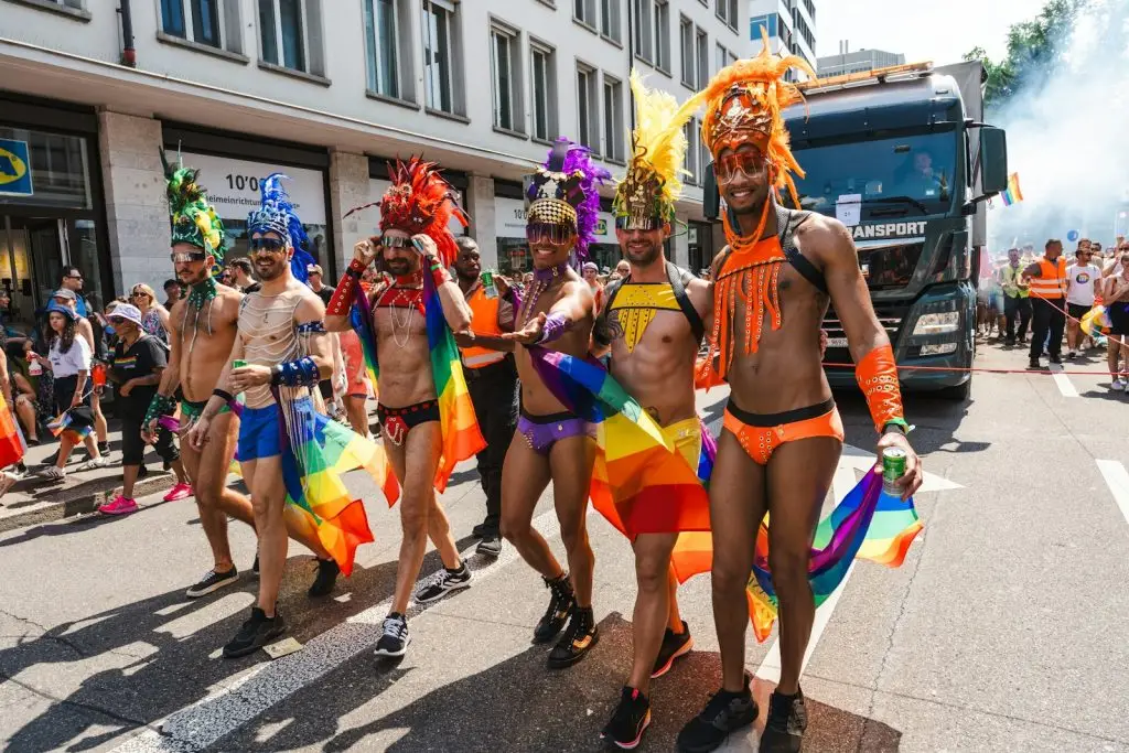 Anti-gay law Africa: a group of men in colorful costumes walking down a street