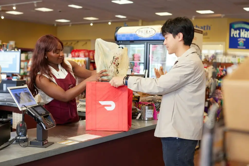 South Africa Smart ID: woman bagging pet supplies in DoorDash bag for customer