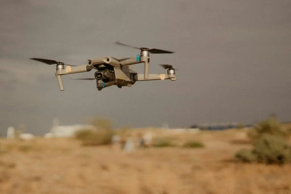 Sudan Drone Strike: white and black drone flying in mid air during daytime