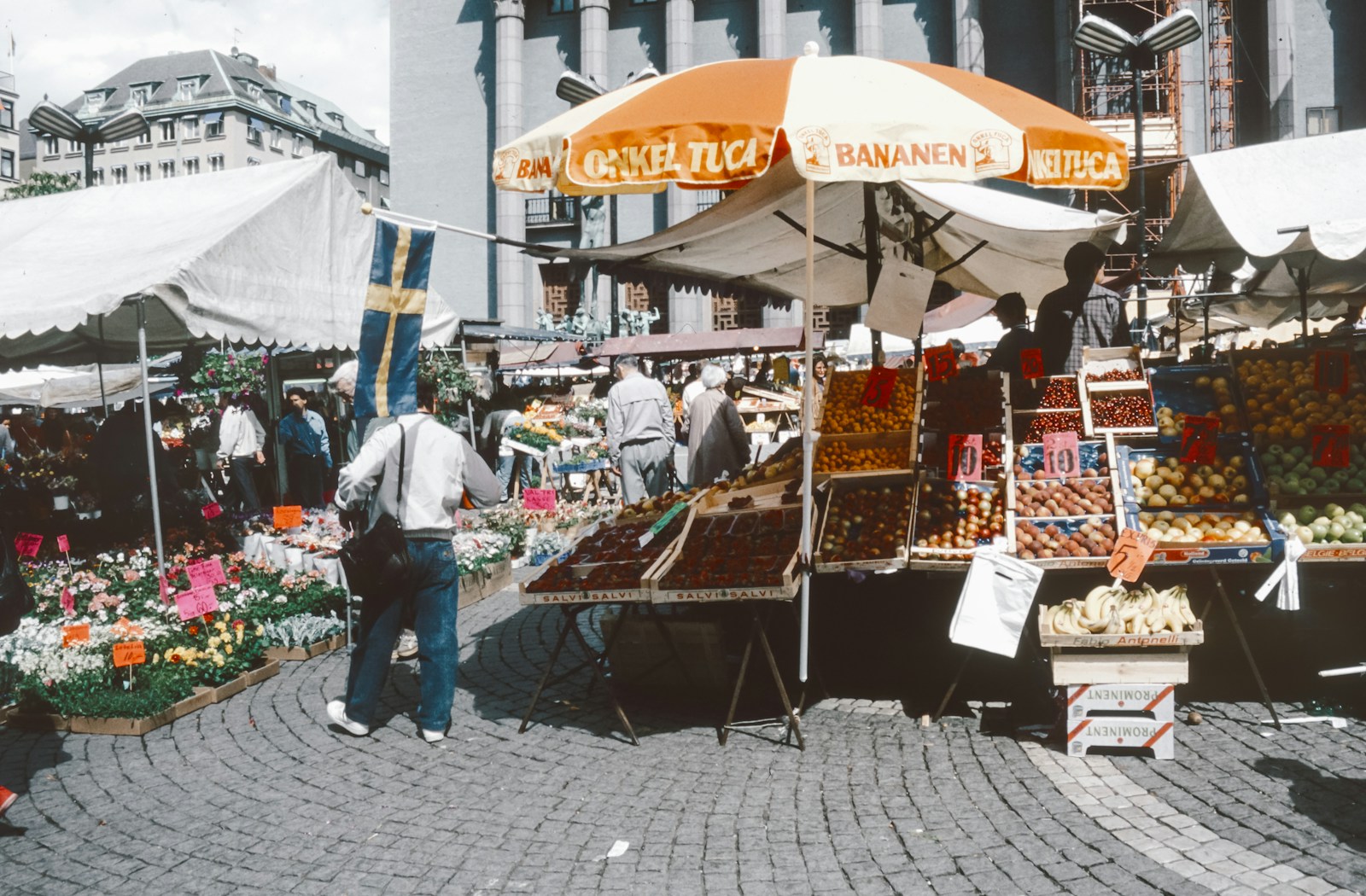 Oranjezicht Market: A man standing in front of a bunch of fruits and vegetables